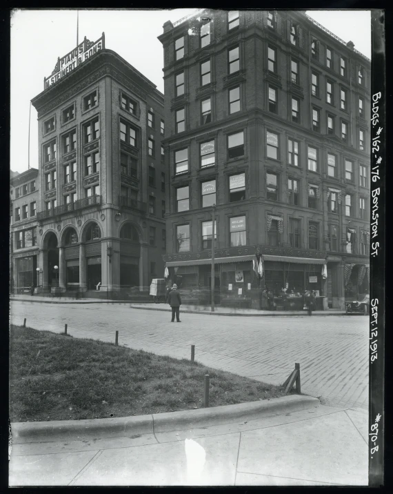 a large building sitting on the corner in a large city