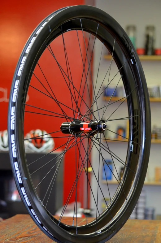 a bicycle wheel is shown from the front with a red light shining through the center