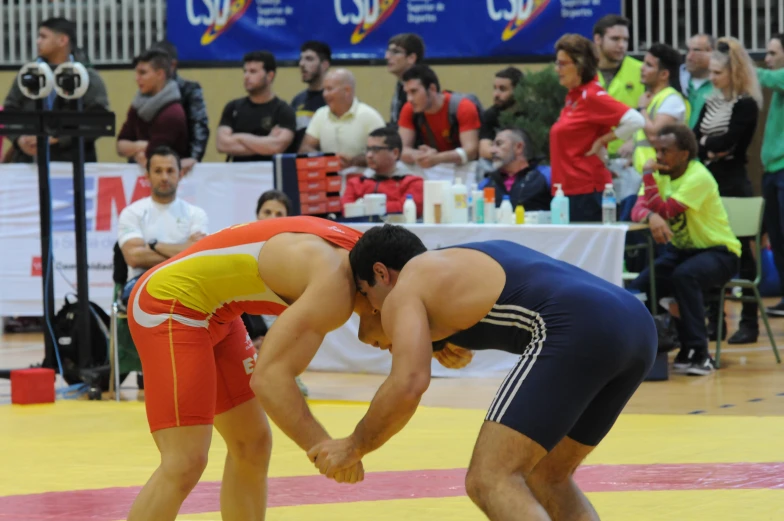 a wrestler trying to grab the leg of another wrestler in the ring