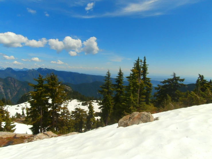 a snowboarder and mountain view in the distance