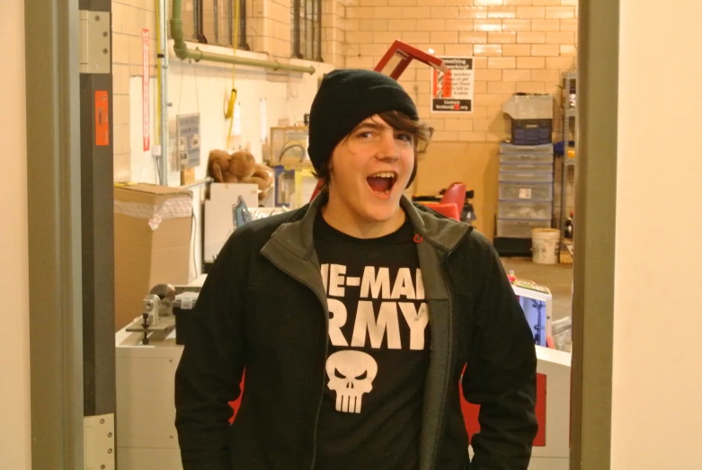 a young man is standing in an empty kitchen