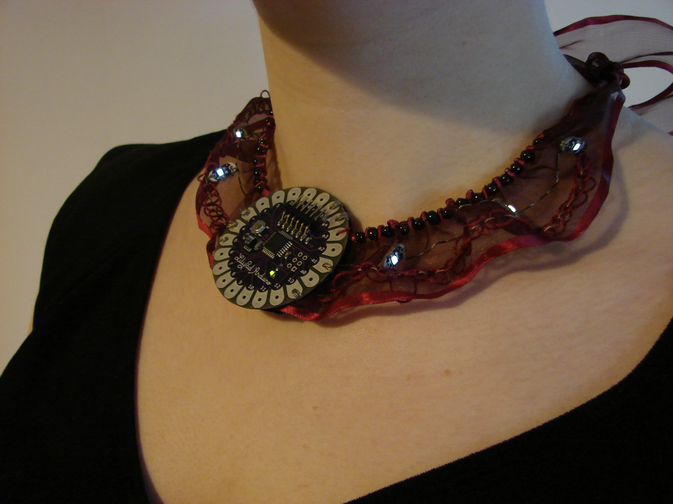 an altered fashion necklace featuring a on and beads