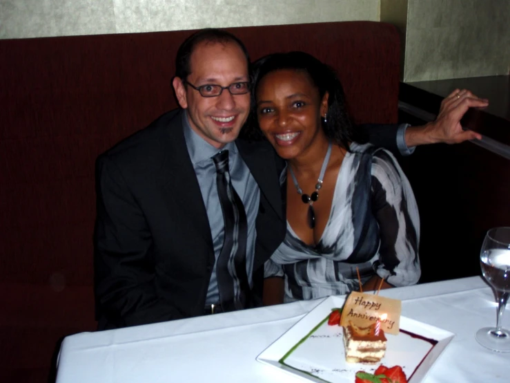 the couple is sitting together at the table