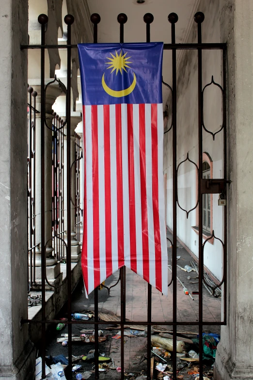 a flag hanging from the side of a metal gate