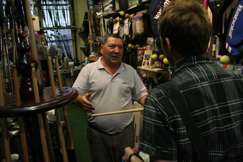 two men look at a display in a store