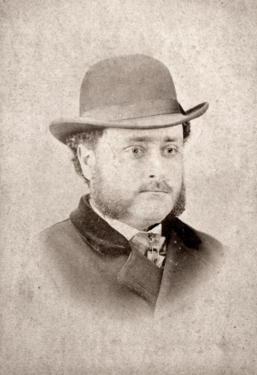 this old - fashioned portrait is wearing a suit and hat