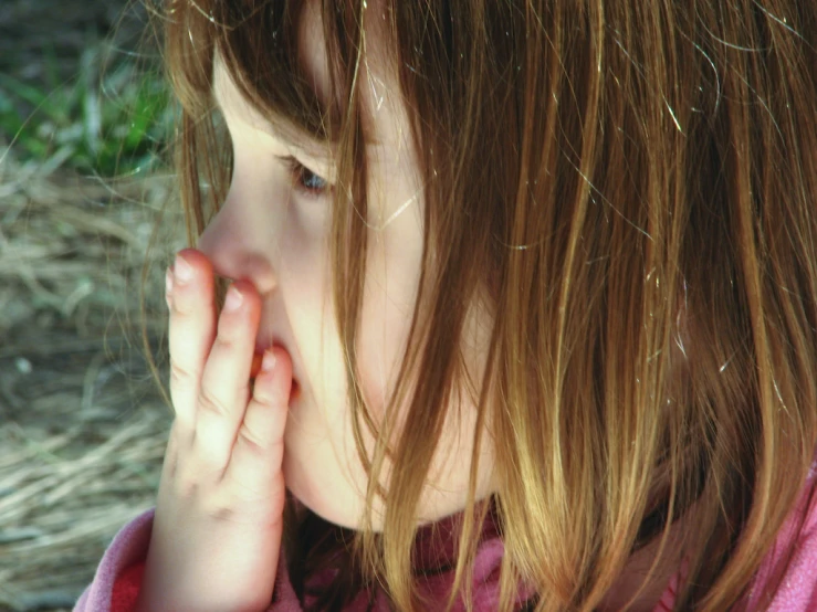 a close up po of a child holding her hands together