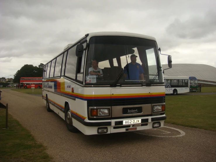 two men on the bus driving down the road