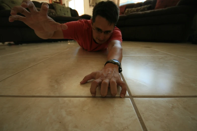 a man who is on the ground holding his hands