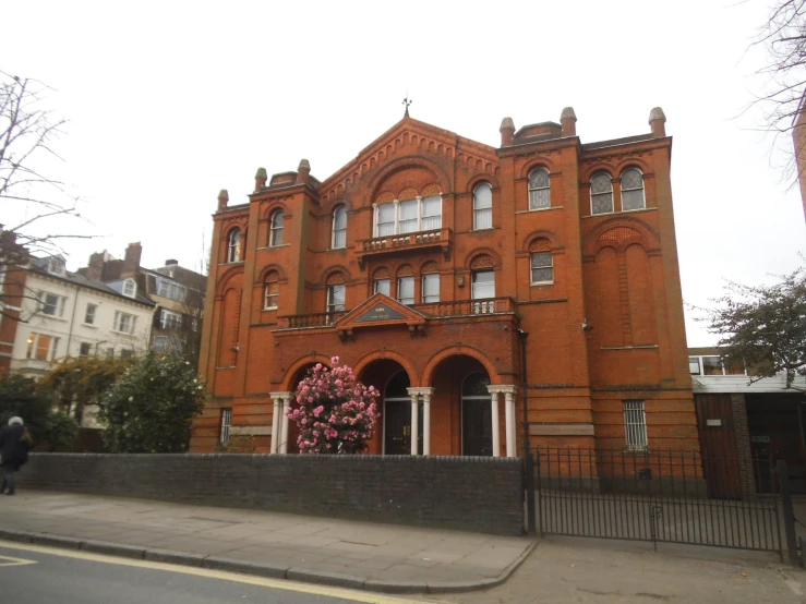 an old red brick building with lots of windows