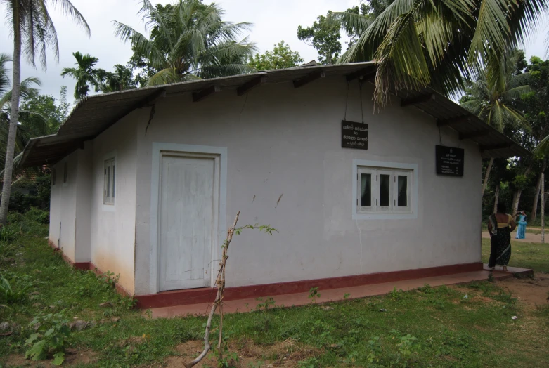 a person standing next to a white building