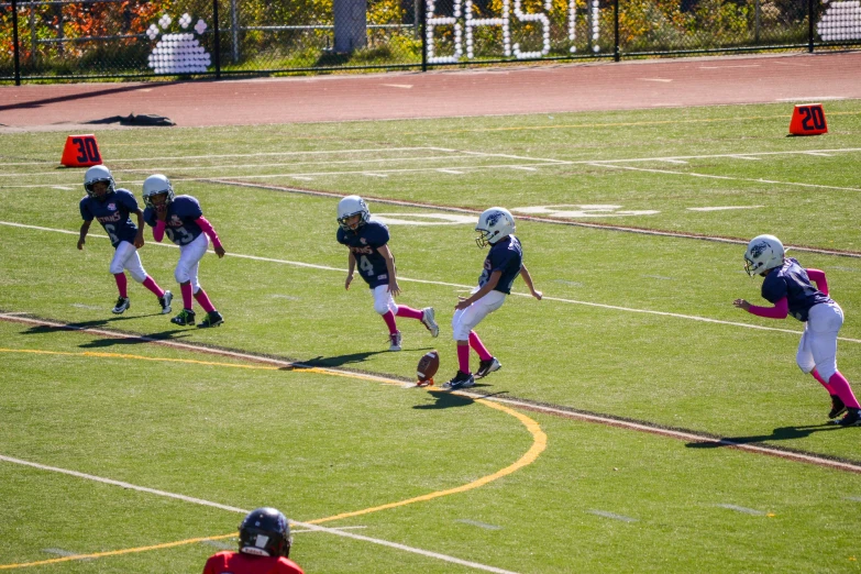 a group of young people playing a game of football