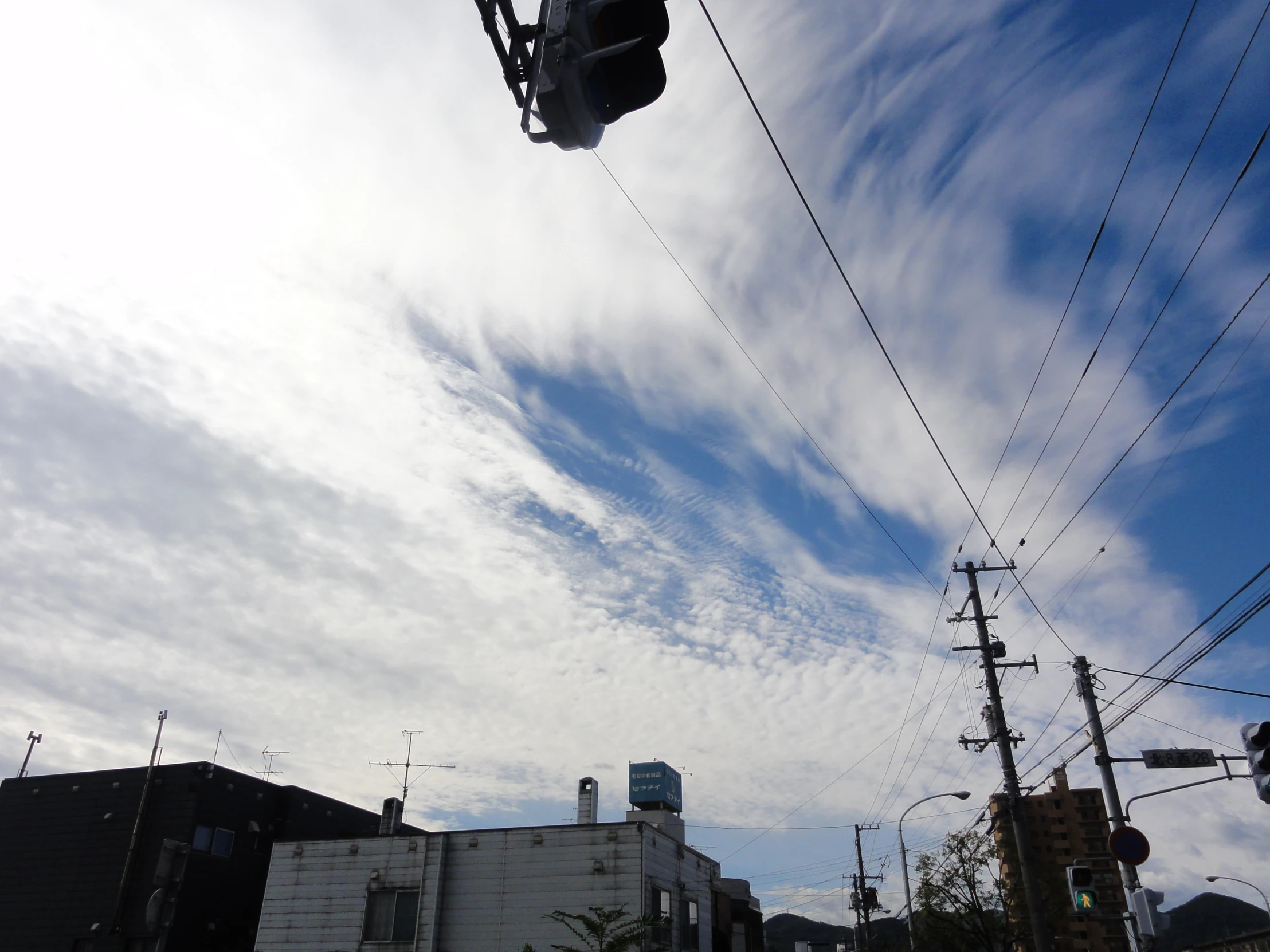 some power lines over houses and a traffic light