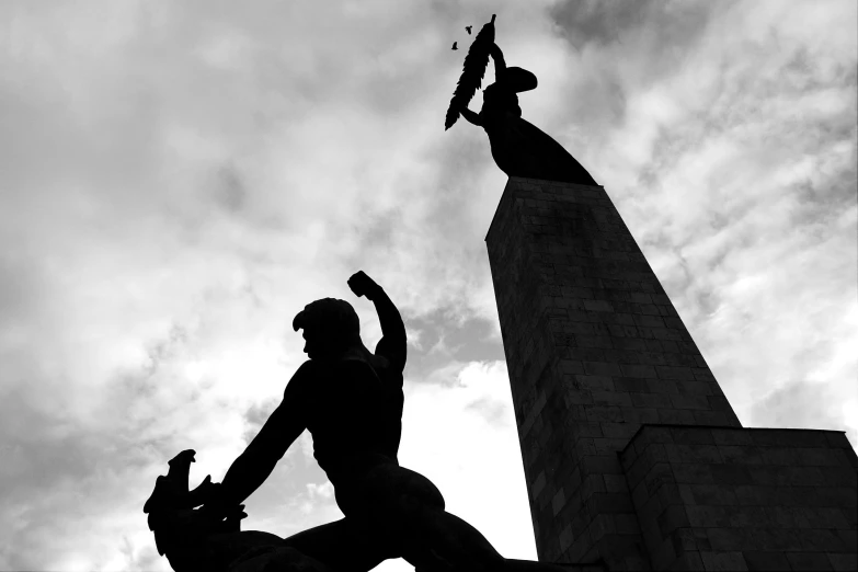 two people that are standing up against a building