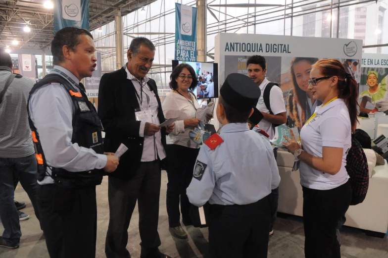 people at a trade fair discussing their equipment