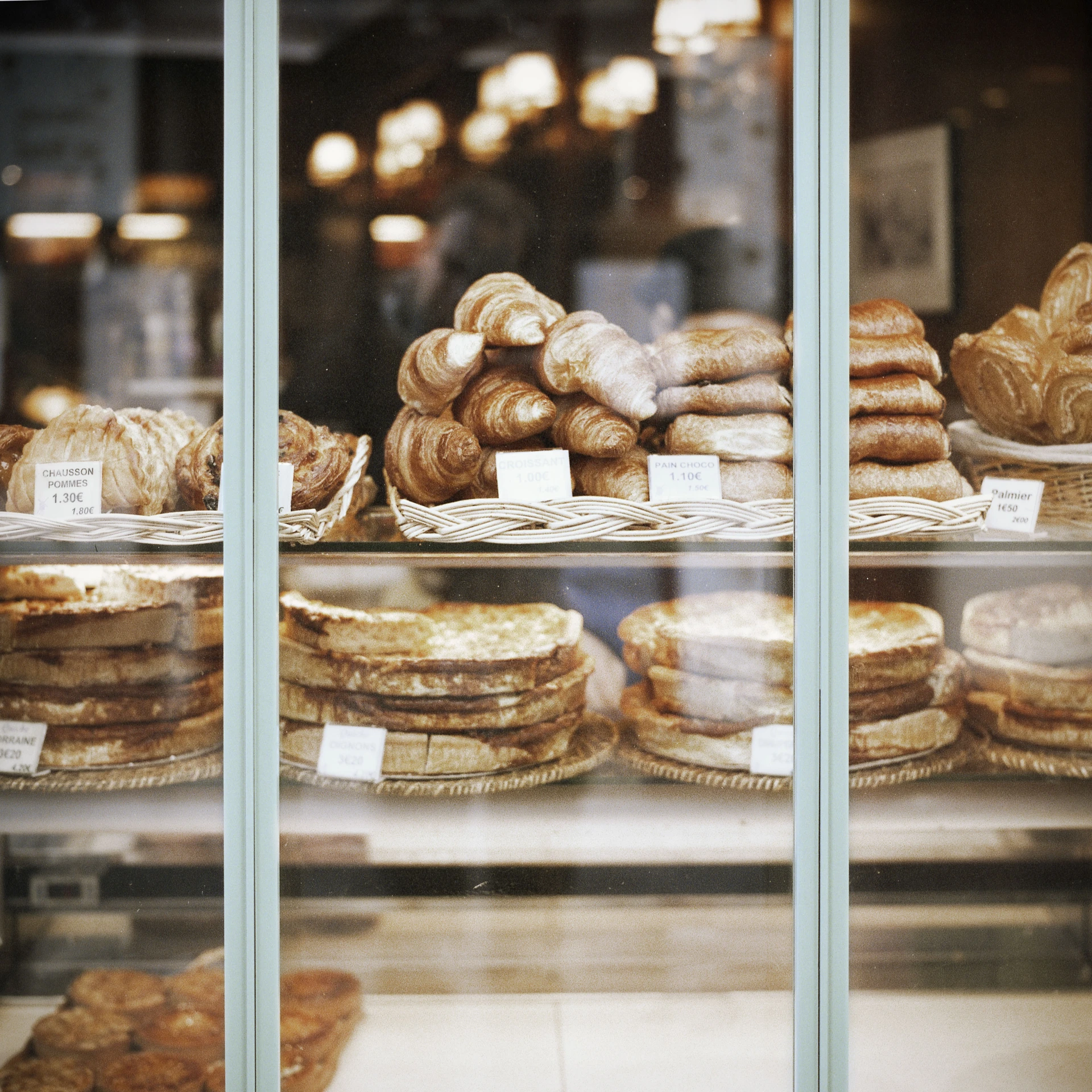 a display case in the bakery with many pastries