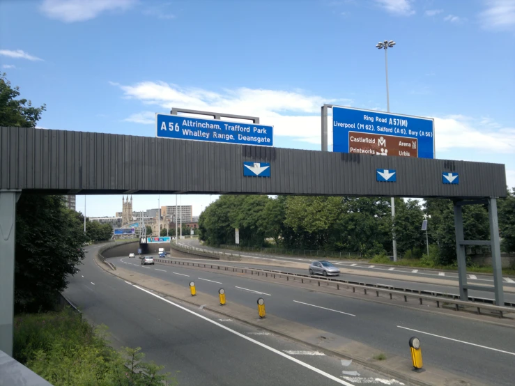 an overhead freeway sign showing directional directions above it