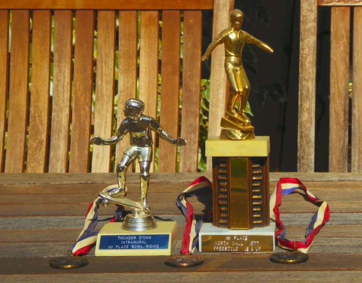 a trophy sits atop a golden statue on display