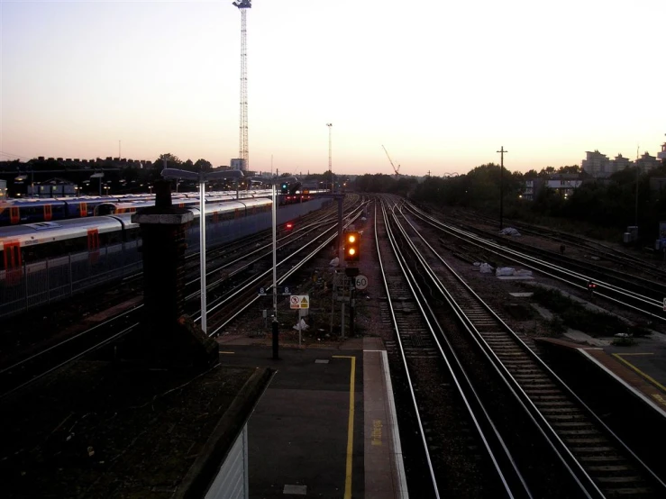 there is an empty railroad with many cars coming up and down the tracks