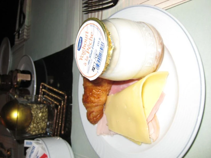 a plate with er, ham and a jar of cheese