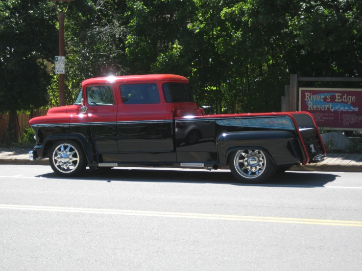 black and red truck sitting in the street