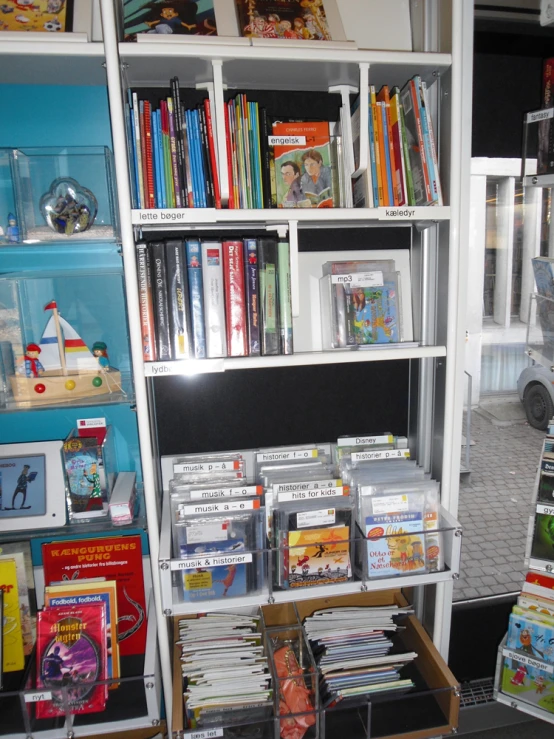 books on the shelves in a playroom with toy cars