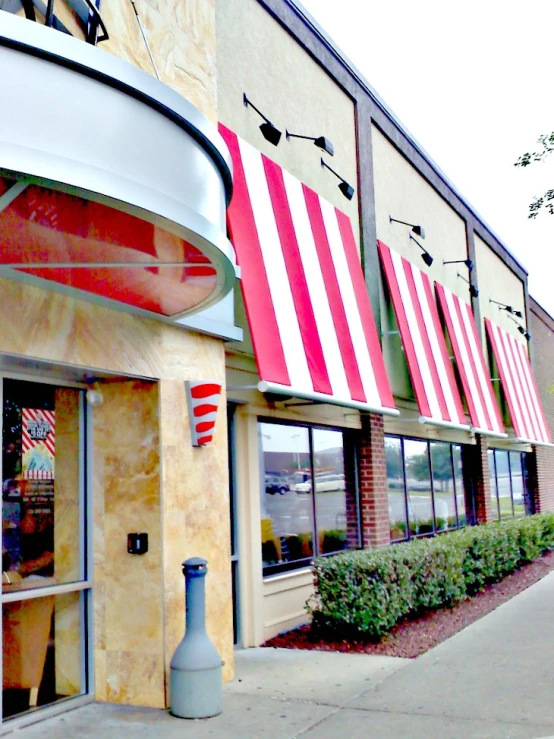 a row of american flags line the outside of a store