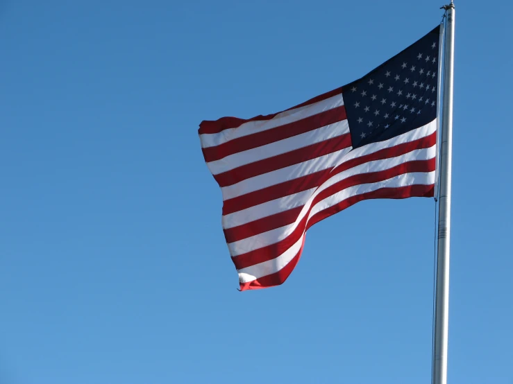 a view of a united states flag waving in the wind