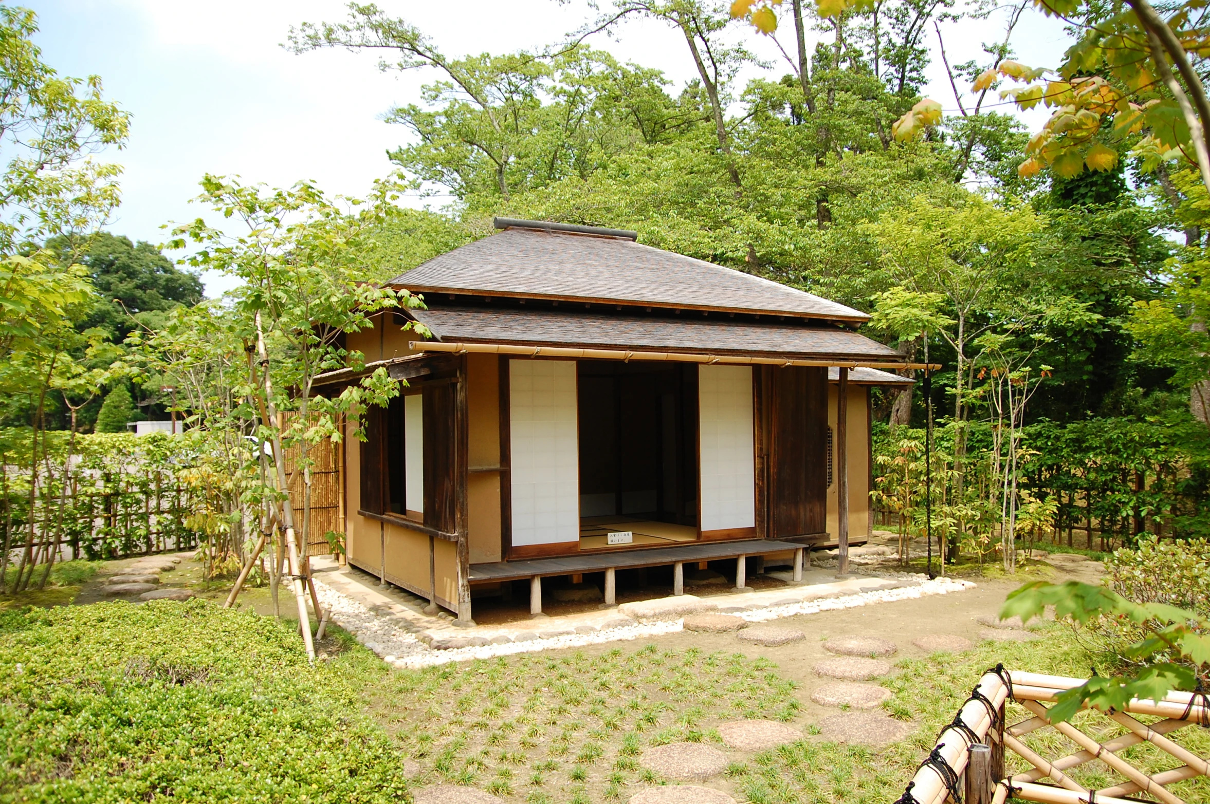 a small house in the middle of a yard