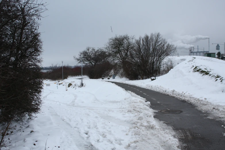 a snowy country road, covered in white stuff