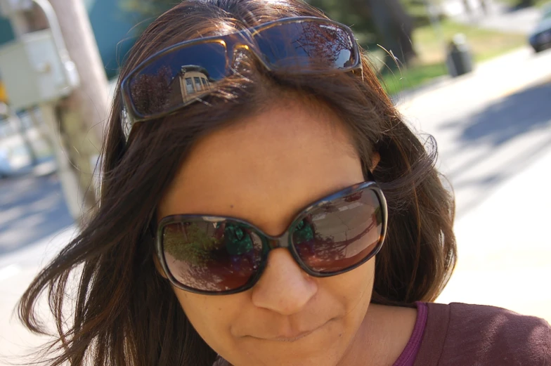 a woman wearing pair of sun glasses while outside