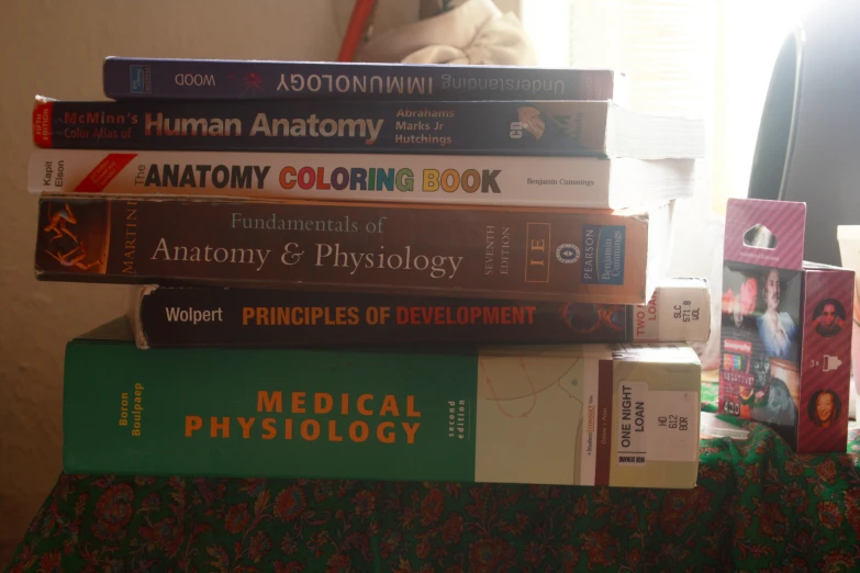 a stack of books, each containing medical and physical topics