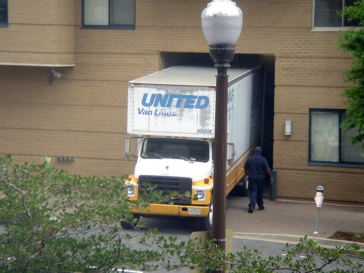 an unteed delivery truck is parked in the driveway