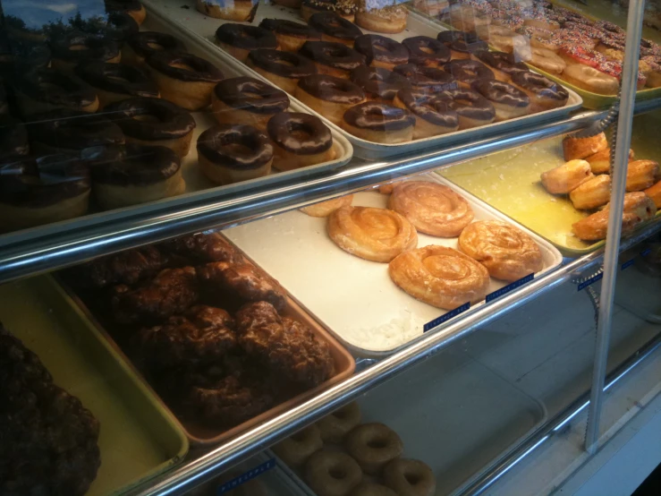 a glass display case with donuts on it