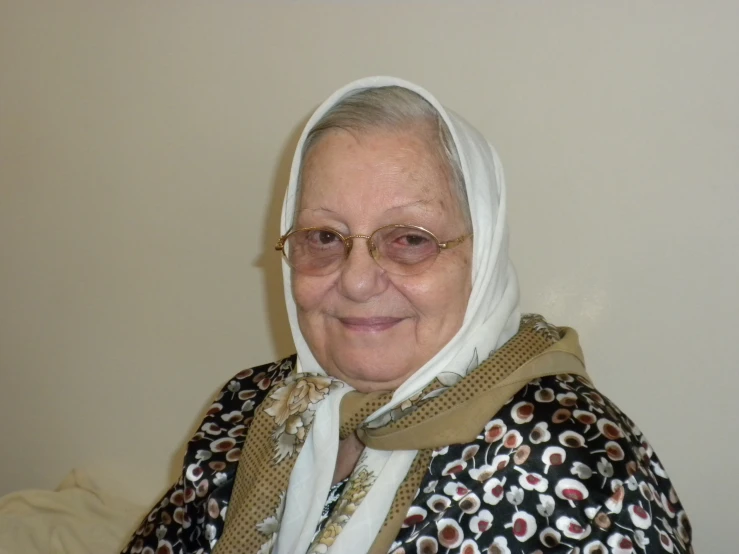 an old lady wearing a headscarf and sunglasses