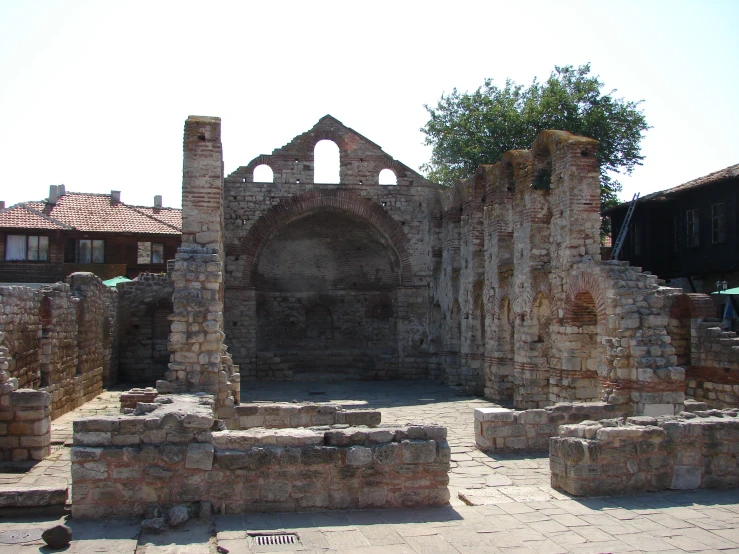 a stone building with a tree in the front