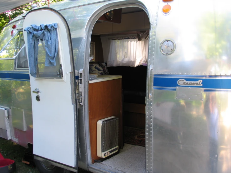 a close up of an old trailer with its doors open