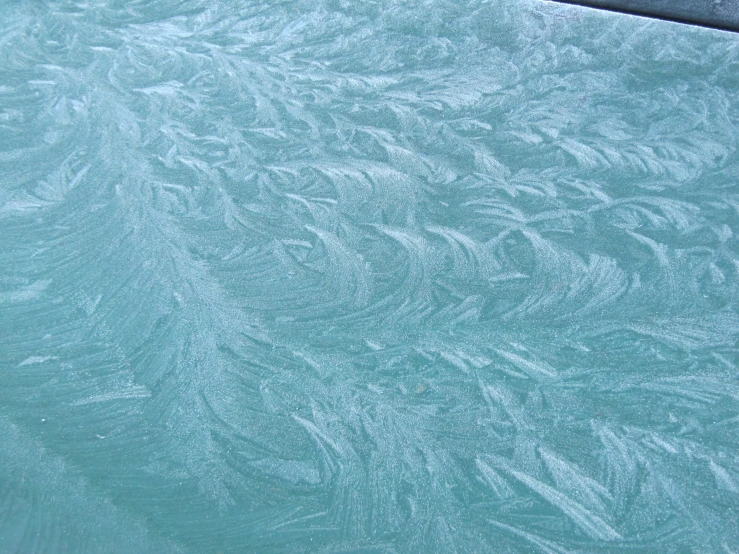 a snowboarder sitting by the edge in blue water