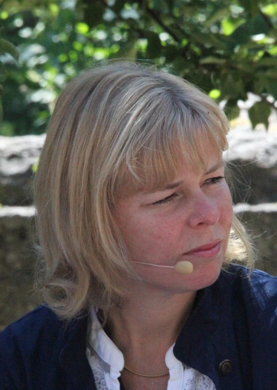 a woman talking on a cell phone while wearing ear buds