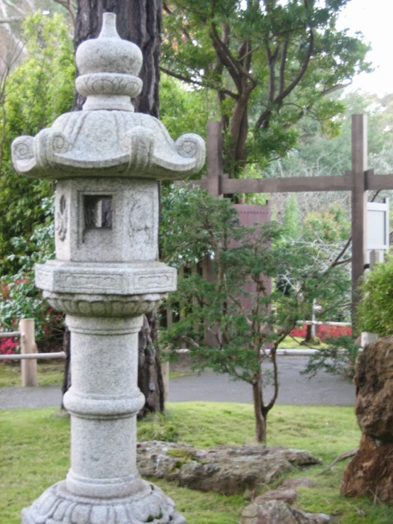 there is a small garden with a fountain on the ground