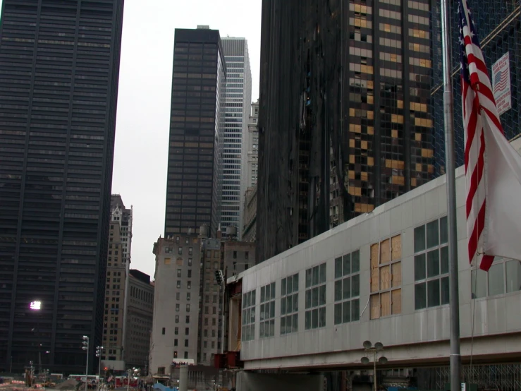 large buildings in the city with flags flying in the wind