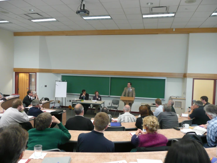 a man is speaking in front of an audience