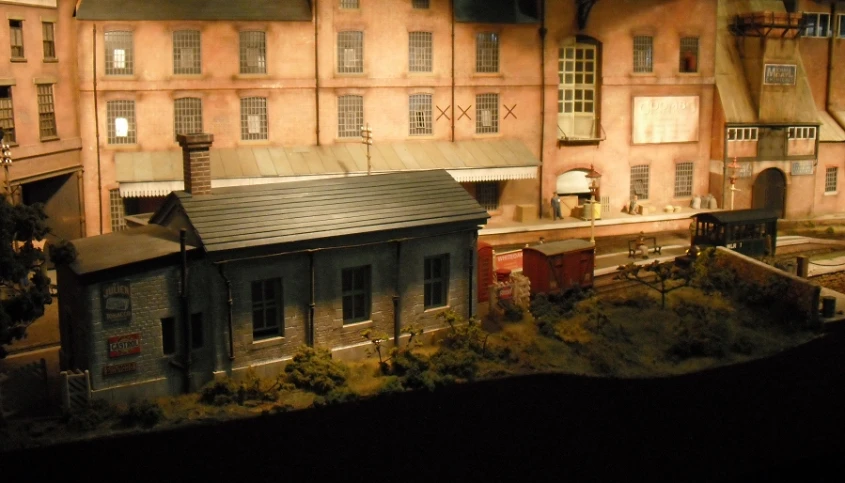 an old building stands next to a toy train