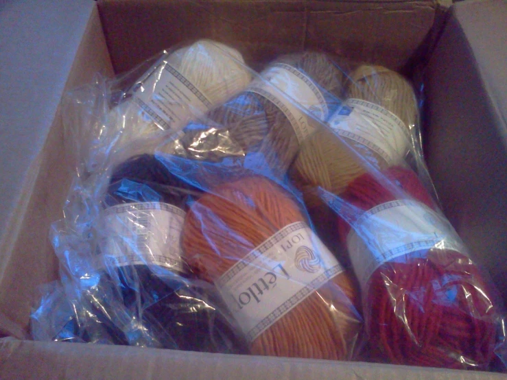 balls of yarn in a box with plastic bags