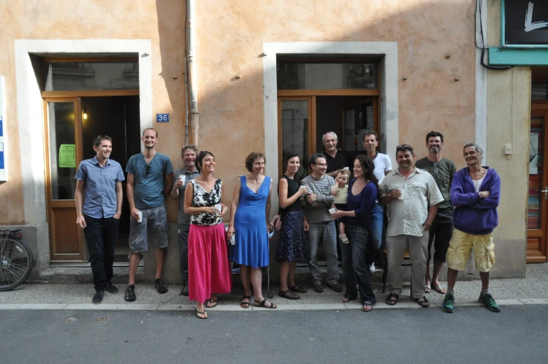 several people standing outside some doors of a building