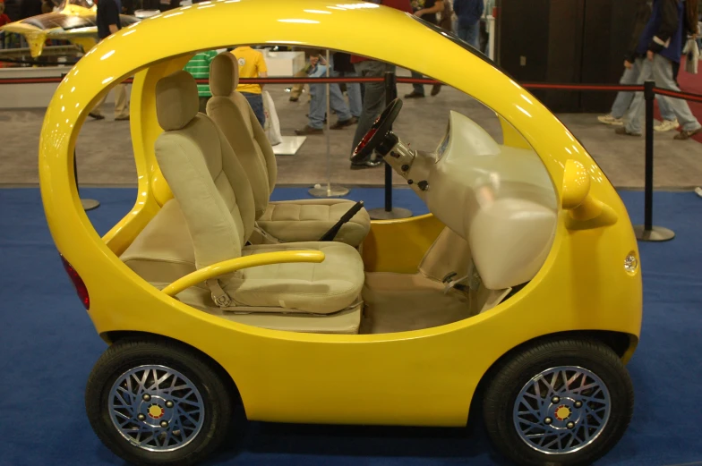 a yellow car with an odd seat inside