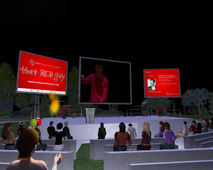 a man standing in front of a group of people on stage with huge screen screens