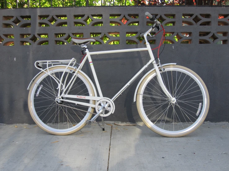 a bicycle parked in front of a fence