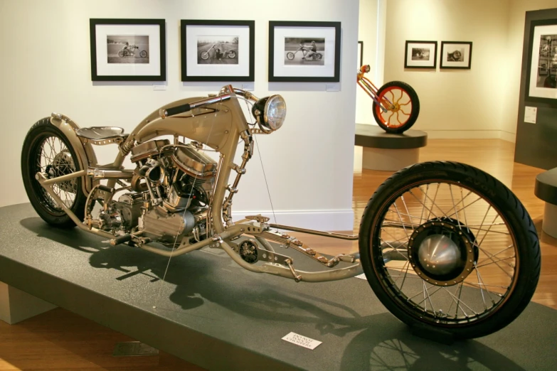 the antique motorcycle is on display on a stand