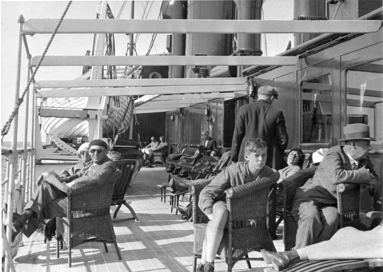 vintage black and white pograph of some people sitting on chairs